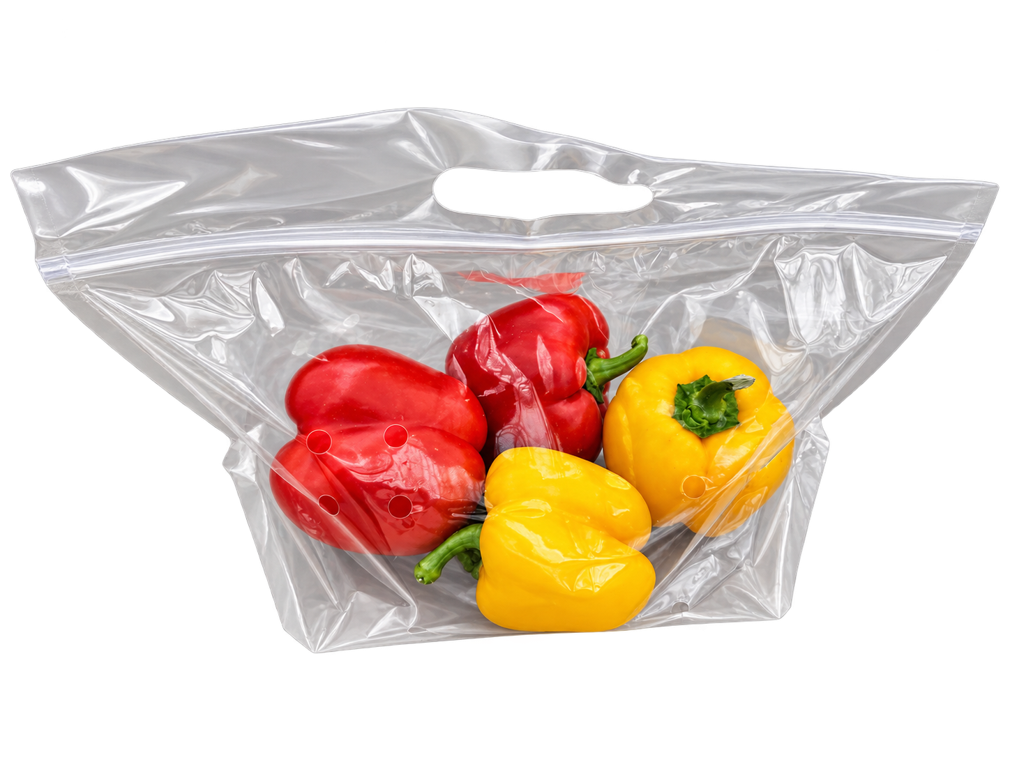 Two red and two yellow bell peppers in a clear bag
